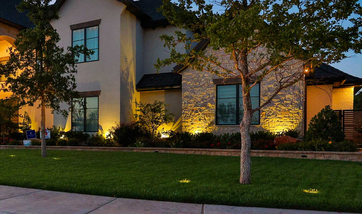 Landscape lighting on a home at dusk